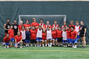 Adaptive soccer players in a variety of pathways huddle in the goal to pose for a photograph at UASA's Adaptive Soccer Camp in Chicago earlier this year