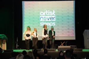 Stage view of performers showcasing their talents from different creative fields during the event.