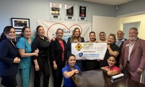 PHS team holding banner and receiving the GrowFL Florida Companies to Watch Awards box with Russel Slappey from Nperspective Fractional CFO & Strategic Services