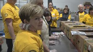 Volunteer Ministers from the Church of Scientology Seattle gather to work at Food Lifeline, packing boxes of food for hungry Seattle families and seniors.