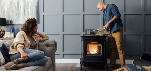 pellets being poured into a pellet stove in a cozy living room