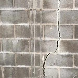 Large vertical crack in foundation wall indicating structural issues