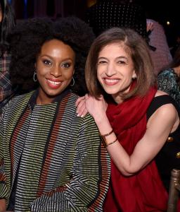 Chimamanda Ngozi Adichie smiling to camera next to Equality Now Global Director Yasmeen Hassan