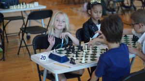 students playing chess in tournament