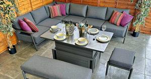 Rattan Garden Furniture LTD aluminium garden furniture corner dining set with grey cushions and rising table, ideal for modern outdoor living.