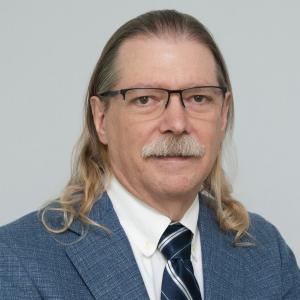 Portrait of Kevin Rebman, board-certified massage therapist and author.