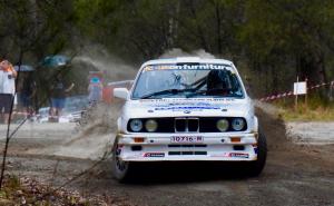 BMW Rally car sliding on a forest road in The Alpine Rally.