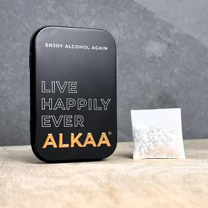 Black ALKAA tin with the slogan ‘Live Happily Ever ALKAA’ next to a white alcohol-adsorbing sachet
