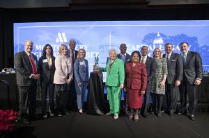Governor Kay Ivey, surrounded by state and local leaders, accepts the Capital Legacy Impact Award.