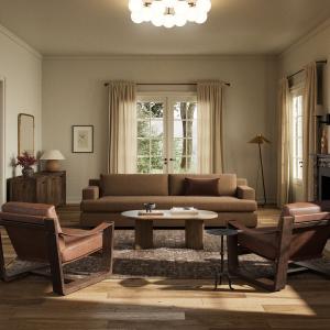 Modern living room with gray upholstered sectional sofa, designer accent chairs, contemporary lighting, artwork, large windows with Pacific Northwest views, and carefully curated home furnishings creating an elegant and comfortable entertaining space.