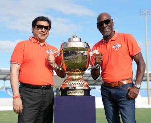 Brijesh Mathur, chairman of Pramanit Global Ventures USA Inc. (PGV), and Sir Vivian Richards pose with the Mayor’s New World T20 championship trophy at Central Broward Park, Lauderhill, Florida.