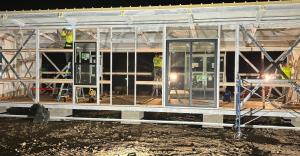 Crews constructing sustainable steel home in post-fire Lahaina at night