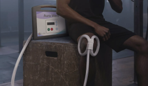 The Aura Wave by AuraWell allows everyday users to now experience the same elite-level recovery benefits as professional athletes, without clinic appointments, staff training, or downtime. Pictured here is the device on the knee