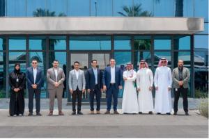 The Baker Hughes and Strataphy teams gather for a group photo in front of the Baker Hughes office in Khobar following the signing ceremony.
