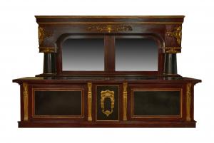 Massive, 20th century Brunswick style, 14-foot-wide mahogany back bar with steeped gilt cornice over scroll decorated frieze featuring cartouche corners. Estimate: $10,000-$20,000.