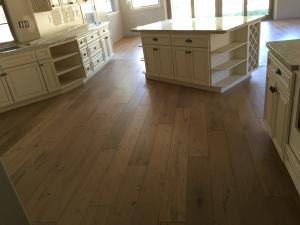 Technicians installing a wood floor in a Sacramento home by Sacramento Valley Flooring.