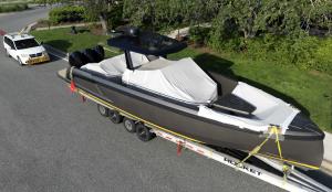 Luxury yacht on a professional Genesis Exotic Transport carrier, highlighting reliable and safe boat transport services across the U.S.”