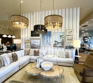 Luxury living room vignette inside Nativa Interiors’ new 5,000-square foot Newport Beach showroom and design center, featuring sculptural lighting, custom millwork, and layered neutral furnishings. Level 3 Construction served as the general contractor of 