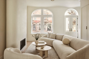 Minimalist living room with neutral furniture, soft lighting, and arched windows, symbolizing structure and stability in recovery.