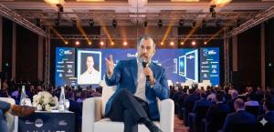 Nick Ayala speaking on stage at a private international business conference in Dubai