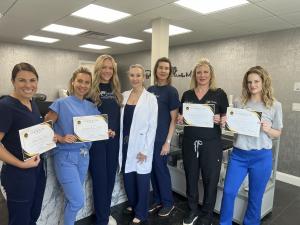 Group of graduates with their certificates.