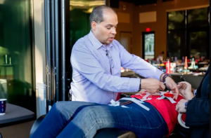 Instructor demonstrating biomagnetic pair therapy techniques during a Dr. Garcia Biomagnetism educational seminar, showing practical application of biomagnetism protocols.