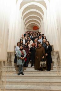 Attendees of the Arm.wool Forum stand beneath a wool installation by Samples Atelier at the HayArt Center, Yerevan