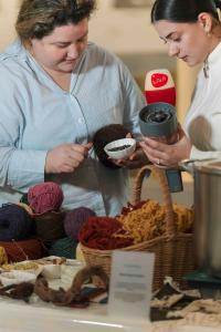 Participants handle Armenian wool and natural dye materials during a workshop focused on restoring generational textile knowledge at the Arm.wool Forum in Yerevan