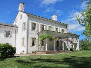 Front view of the mansion at Morven, a white building in the Georgian style of architecture, on a spring day.