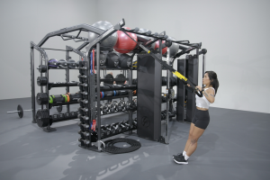 A single female exerciser using straps to complete an upper body exercise