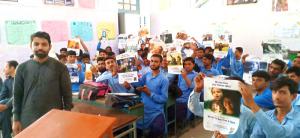 Students at a government school near Islamabad hold up posters with the articles of the Universal Declaration of Human Rights included in the educators' package available through the Youth for Human Rights website.