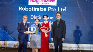 Kerry Guo, Founder and CEO, Robotimize Group, accepting the "Technology for Good" award from a government official and a corporate chairman on a gala stage