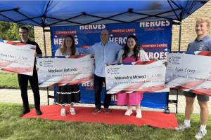 Dr. Kevin Greene with four Confidia Cares scholarship recipients holding scholarship checks at the Confidia Cares: Alumnus Scholarship Ceremony honoring fallen local heroes in Connecticut.