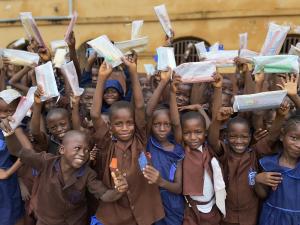 Students at a Sierra Leone school receive pencils through Develop Africa’s Year of the Pencil campaign, giving them essential tools for learning.