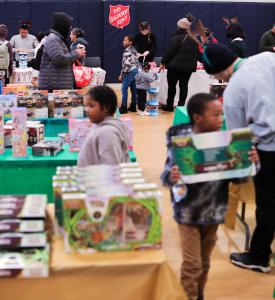 Children and families browse toys during The Salvation Army of Greater New York’s Parent’s Choice His Toy Store event, where parents were able to “shop” for holiday gifts in a festive, dignified setting.