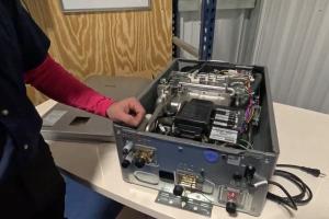 Master Plumber reviews internal components of a tankless water heater to explain scale damage.