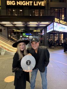 Samantha Rae and Jay DellIsola holding the Boston Music Award trophy, smiling together after their 2025 win.