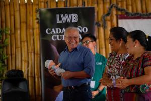 Dr. Guillermo Gaitán speaks to a group of seated midwives during a newborn cardiac screening training in San Lucas Tolimán, Guatemala.