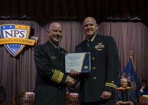 Vice Chief of Naval Operations U.S. Navy Adm. James W. Kilby, a Naval Postgraduate School alumnus, congratulates a new alum during the Fall Quarter Graduation Ceremony, Friday, Dec 19.