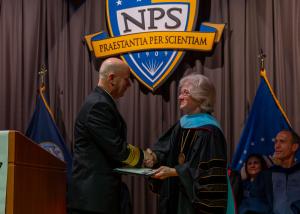 U.S. Navy Adm. James W. Kilby, vice chief of naval operations and a Naval Postgraduate School alumnus, receives the NPS Distinguished Alumnus Award from university president, retired U.S. Navy Vice Adm. Ann Rondeau.