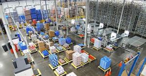 Wide view of the main palletizing floor at Del Papa Distributing, showing Block One's Pallet Factory robotic arms and automated systems stacking cases of beer onto pallets inside a beverage distribution warehouse.