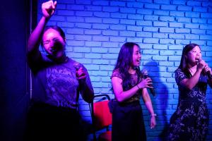 Three female karaoke singers perform at Astronaut City