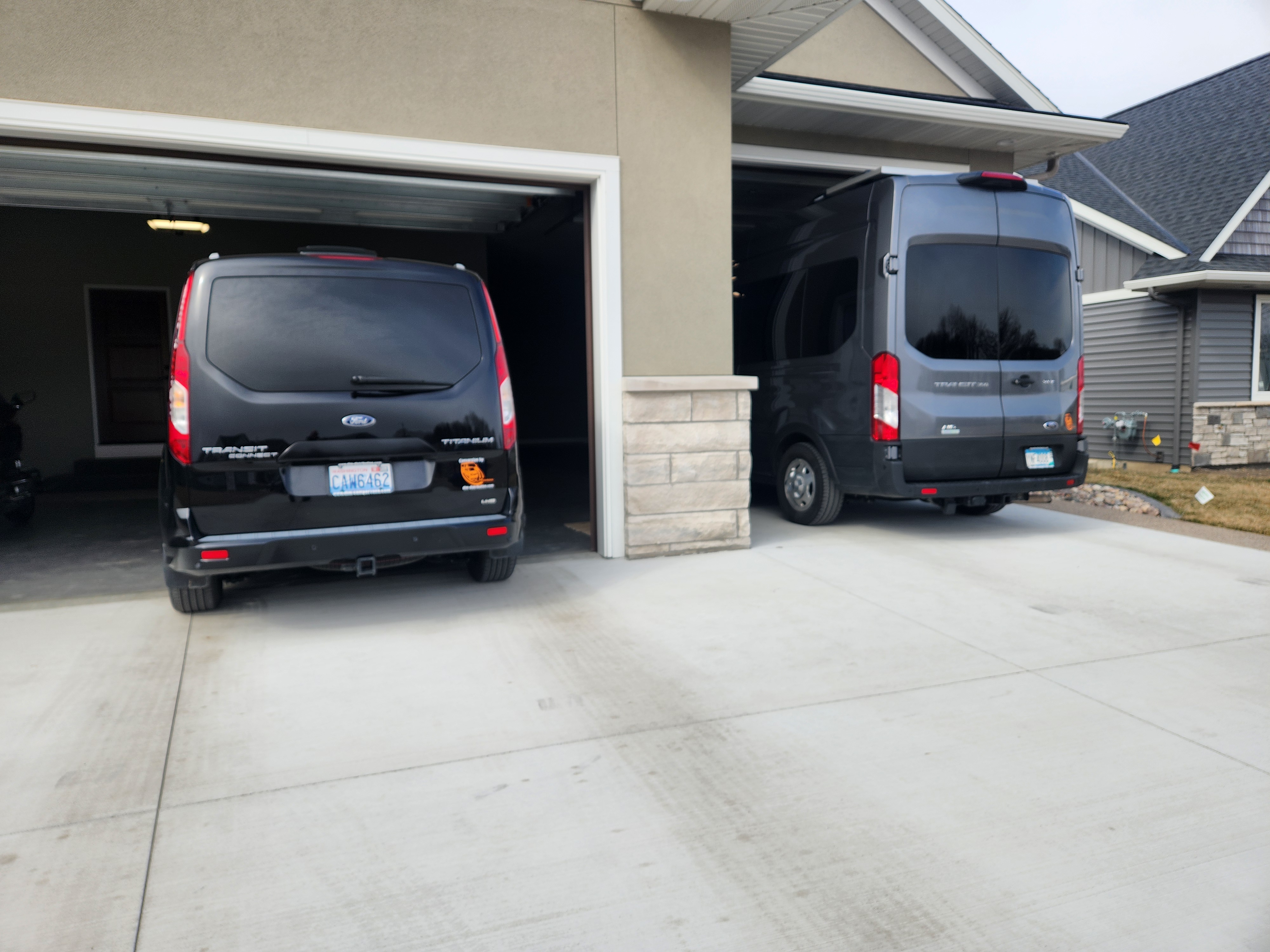 Compact Class B campervan stored inside a residential garage, illustrating garage-compatible RV ownership within HOA housing environments.
