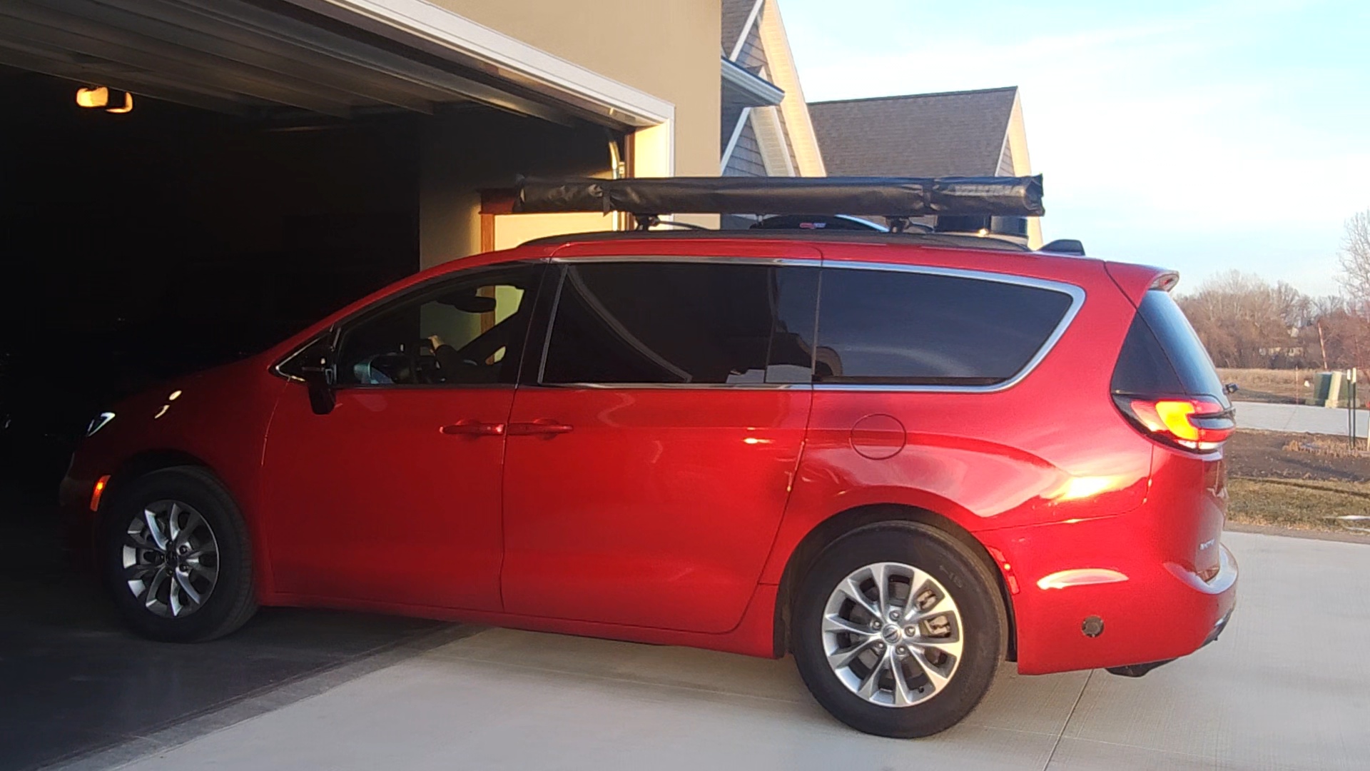 Compact Class B campervan parked inside a residential garage, demonstrating HOA-friendly storage and garage-compatible RV design.
