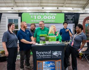 Vendors are smiling and taking a picture at a Nationwide Expos home show.