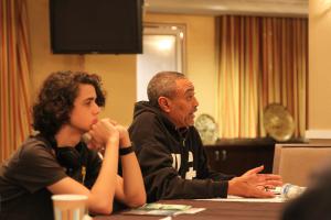 A member of Washington, DC’s, vibrant Ethiopian community explains rights issues, as a youth participant listens.