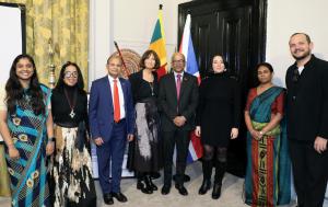 Group photo at the Sri Lanka High Commission in London showing programme partners, designers, researchers, diplomats, and staff standing together in front of Sri Lankan and UK flags during the EU–Sri Lanka Craft Matchmaking Programme milestone event.