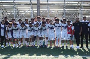The soccer team celebrating with Coach Ivan Todorovic after winning the first trophy in CIU’s history.
