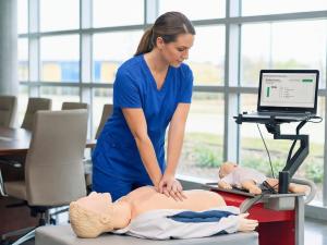 A nurse practices her CPR compression skills