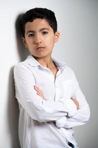 Portrait of Ehsan Adouane, a 12-year-old STEM YouTuber from Dubai, launching a free educational app to make learning accessible worldwide.